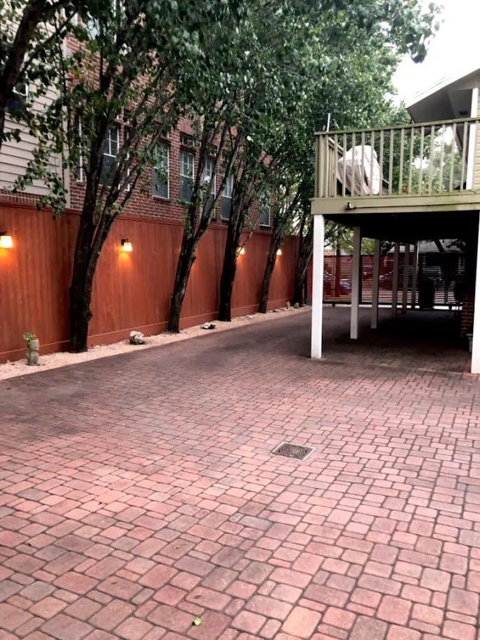 A restored brick paver drive running beneath a carport, cleaned and re-sanded.