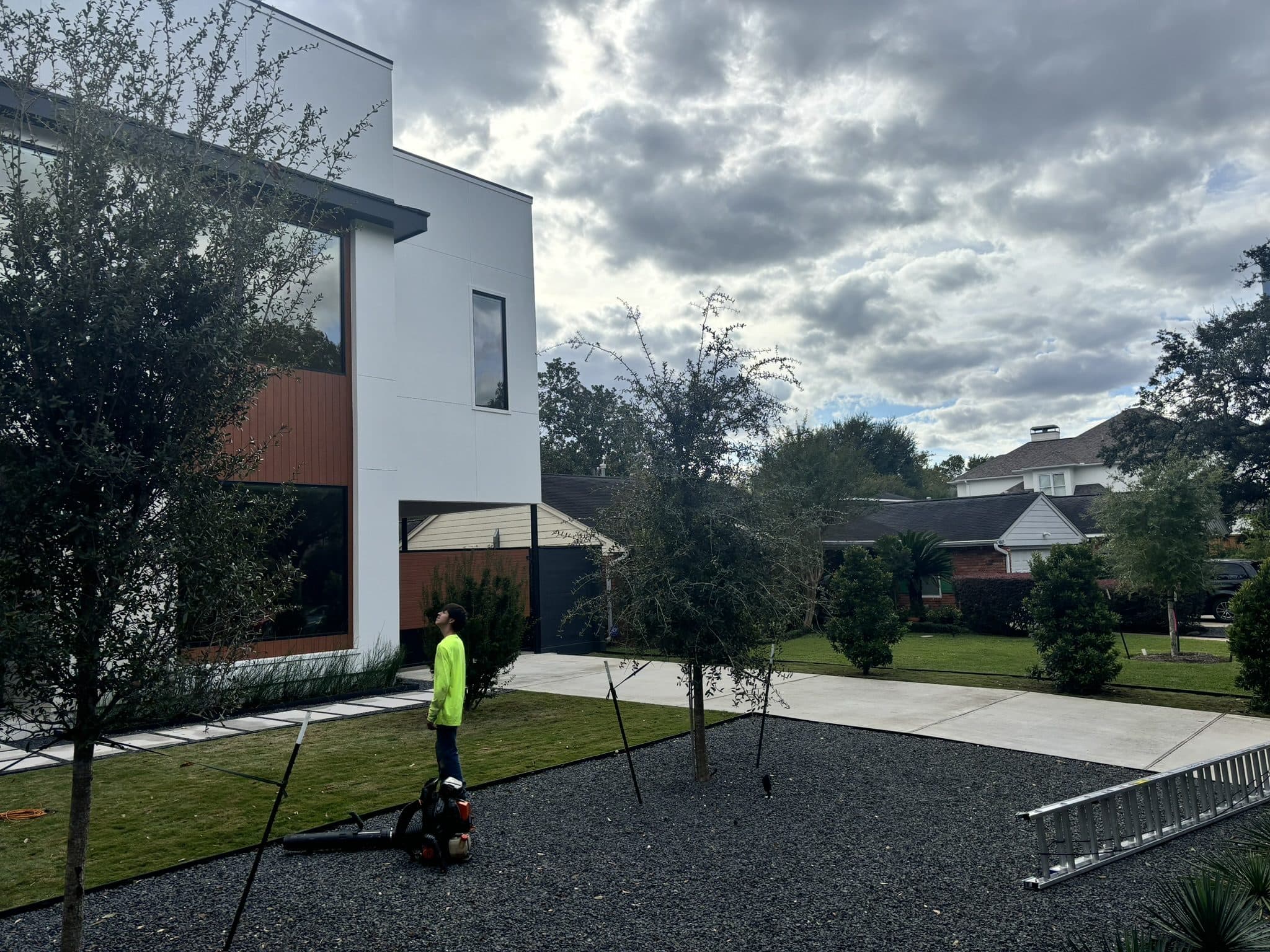 Decomposed granite frontage and new trees going in at a modern Houston property.