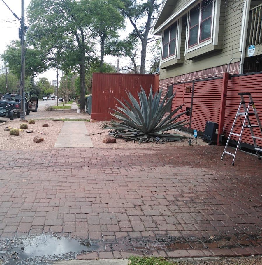 A brick paver drive being washed down as part of a hardscape restoration.